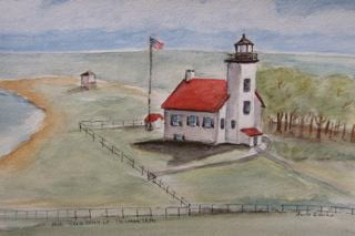 Escanaba Sand Point Lighhouse on shore, surrounded by field and fence 