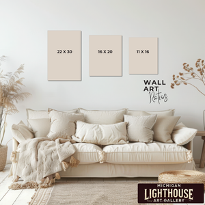 Beige sofa with decorative pillows in a room with wall art and measurements displayed.