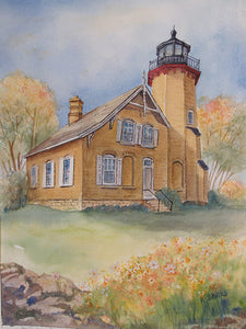 A painting of the McGulpin Point Lighthouse in cream brick with a summer scene, featuring green trees and flowery field in the foreground.